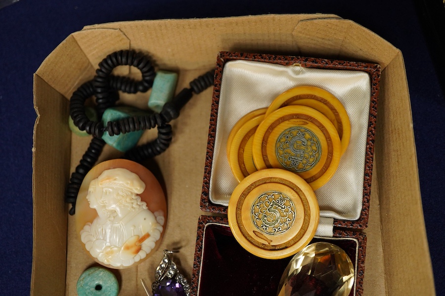 A group of jewels, comprising: three carved coral beads depicting classical women; a synthetic colour-change sapphire and paste pendant; a citrine drop pendant; a bar brooch with a scaraboid carnelian bead carved with an